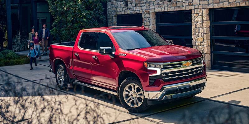 A red Chevrolet Silverado 1500 parked in a driveway