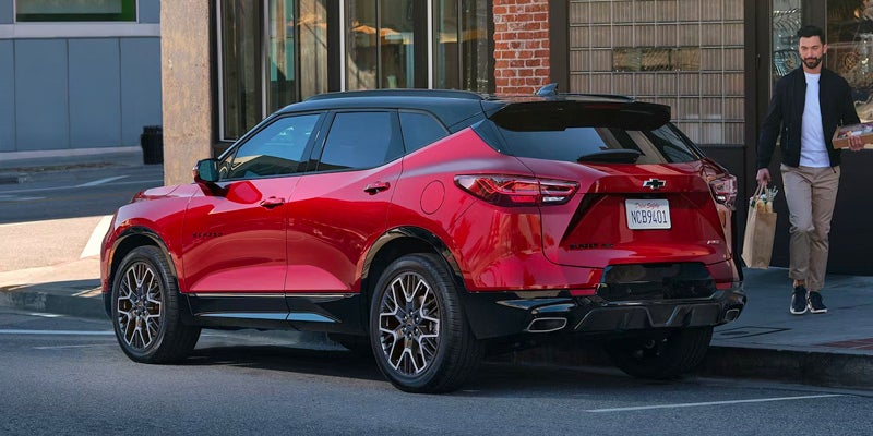 A red Chevrolet Balzer parked on the side of a street.