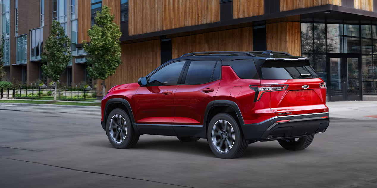 A red Chevrolet Equinox driving